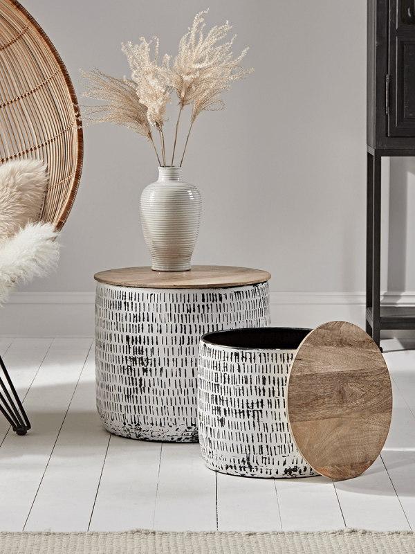 Our statement storage tables are perfect for storing throws, cushions and unsightly clutter with style. Made from zinc with a debossed stripe pattern, distressed enamel finish and with removable mango wood tops, these unique pieces add a touch of texture and warmth to any neutral space.  Perfect when used as coffee or side tables, the smaller table also nests neatly inside the larger.